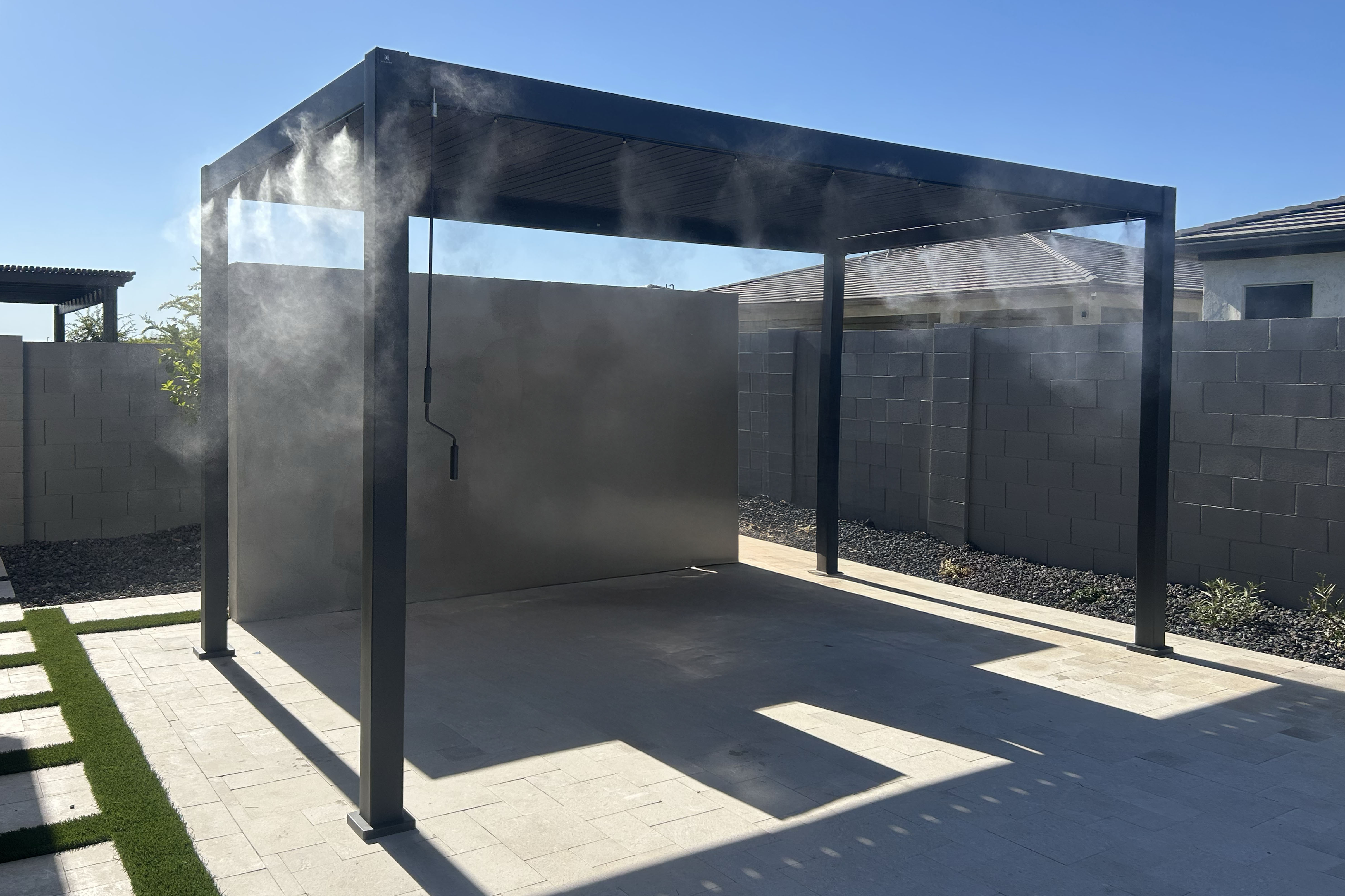 Pergola with integrated mist line routing in daylight